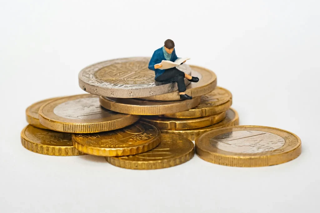 man sitting on top of coins