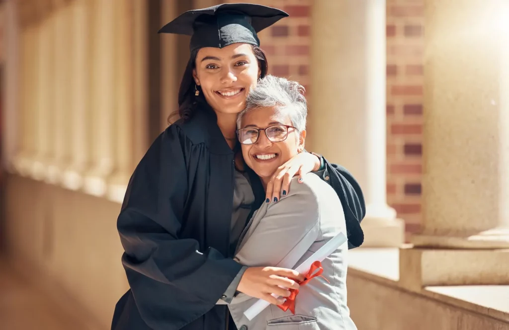 Mother and daughter celebrating graduation after saving for college.