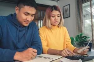 young asian couple-managing investment plan